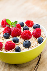 Oatmeal porridge with berries. Raspberries and blueberries.