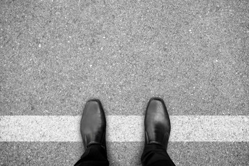 Black shoes standing on white line - 118736307