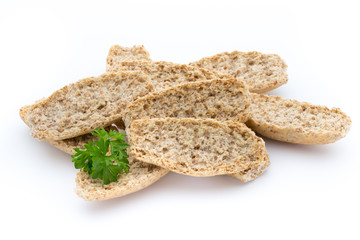 Dry flat bread crisps with herbs on a white background.
