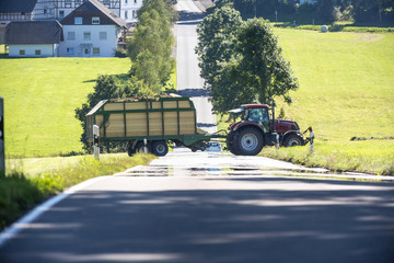 Obraz premium tractor crossing a country road