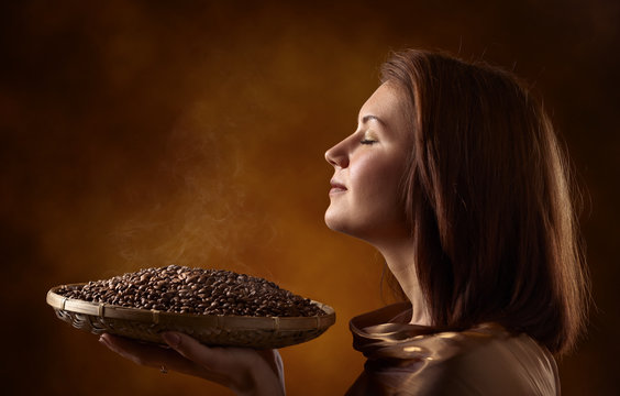 Young Pretty Woman With Coffee Beans