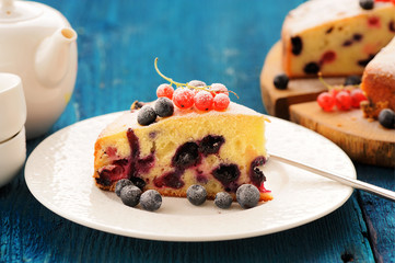 Homemade yummy cake with blueberries and red currants