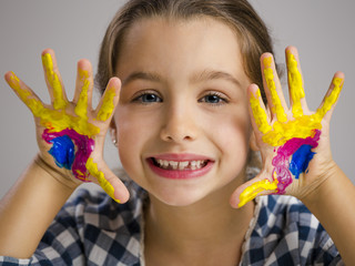 Little girl with hands in paint