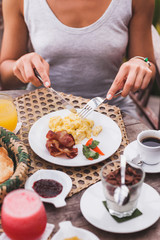 Woman hands holding a knife and fork at lunch outdoors