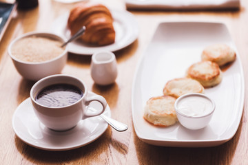 Breakfast: fresh coffee, croissant and cheese cakes