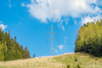 Electric power transmission energy line tower high voltage wire cable pylon field meadow forest view