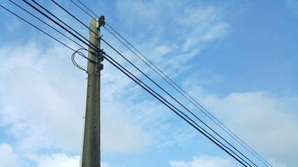 Fototapeta premium electrical high tension lines against blue sky