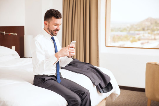 Businessman using smartphone in a hotel