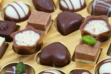 Assorted white and milk chocolates, closeup
