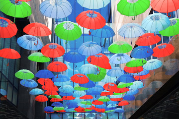 Fototapeta na wymiar Colorful umbrellas over head