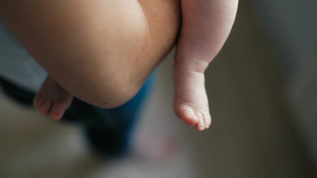 Baby feet being held by adult hand