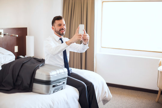 Businessman taking selfie in his hotel room