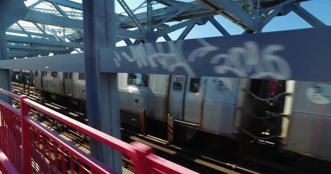 Chasing a New York City subway train on the Williamsburg Bridge over the East River between Manhattan and Brooklyn.  	