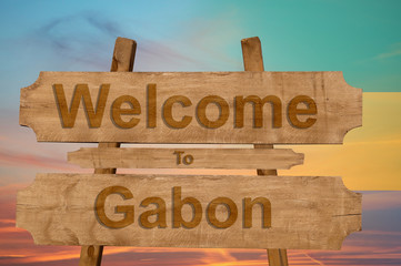Welcome to Gabon sing on wood background with blending national flag