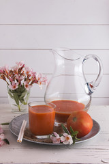 Tomato gazpacho soup in glasses over white background