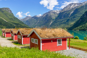 Red houses with typical grass roof, camping on the lake Lovatnet, Norway