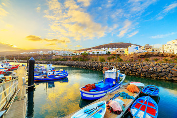 Sunset over a port in Gran Tarajal, Fuerteventura, Canary islands - obrazy, fototapety, plakaty