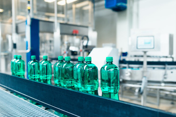 Water bottling line for processing and bottling pure mineral carbonated water into bottles. Selective focus.