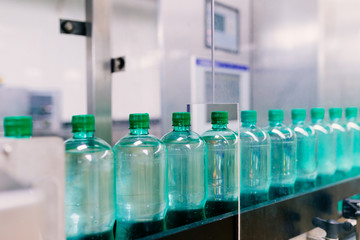Water bottling line for processing and bottling pure mineral carbonated water into bottles. Selective focus.