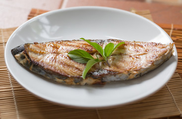 A fried fish on plate.