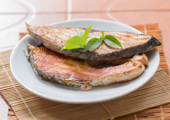 A fried fish on plate.