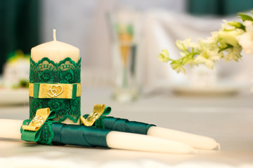 White wedding candles with green decoration