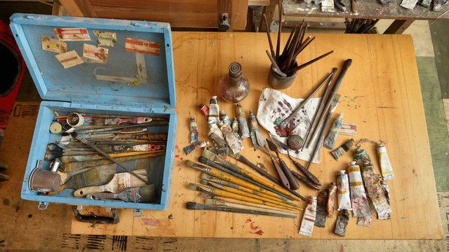 scattered on the table tools of the painter
