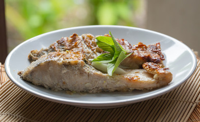 A fried fish on plate.