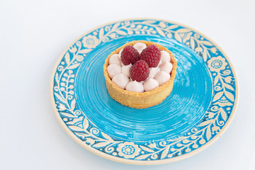 Fresh Fruit and Cream Mini-Tart on the blue rustic plate. Fruit dessert. - 118757904