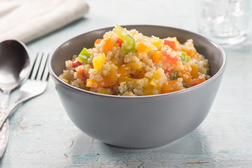 Close up of quinoa salad on blue old wooden table