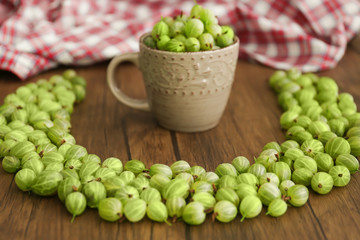 Gooseberries with cup on table