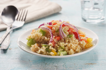 Close up of quinoa salad on blue old wooden table