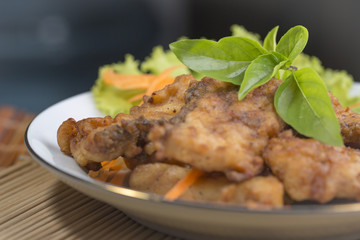 A fried food and herb on plate.

