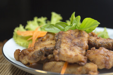 A fried food and herb on plate.

