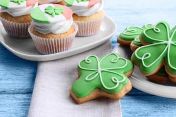 Tasty cupcakes and cookies on plate. Saint Patrics Day concept