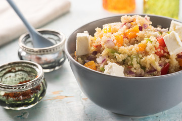 Close up of quinoa salad on blue old wooden table