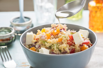 Close up of quinoa salad on blue old wooden table