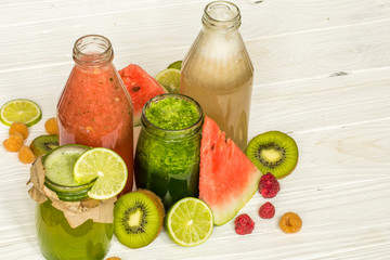 green and red smoothies in a jar with lime