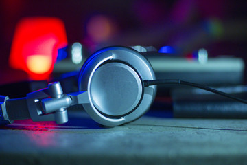 headphones on dj board in night club