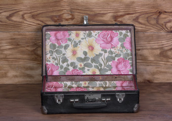 old suitcase on a wooden background