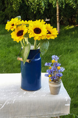Bouquet of sunflowers and floral arrangement with cornflowers an