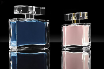 blue and pink elegant perfume bottles in black background