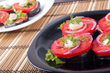 Vegetable dishes of stewed eggplant and fresh red tomato