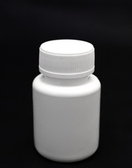 bottle of pills on black