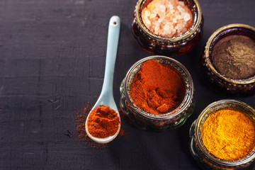 Colorful oriental spices on black table
