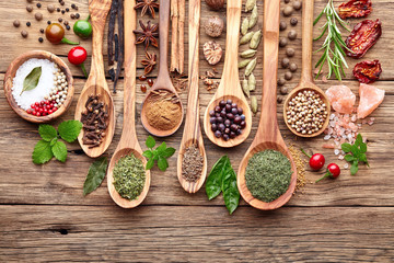 Spices with fresh herbs on a wooden background - obrazy, fototapety, plakaty