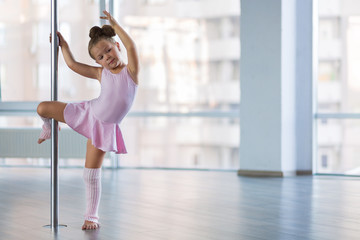 Adorable girl dancer in the ballet studio