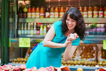French woman choosing fruits on market