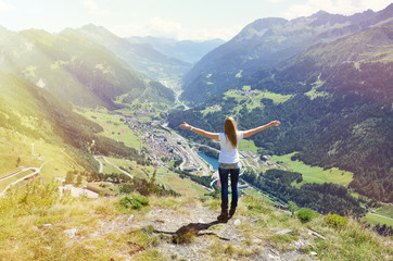 Girl enjoying Alpine scenery at Gotthard pass, Switzerland