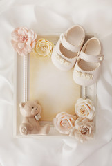 frame background and baby shoes